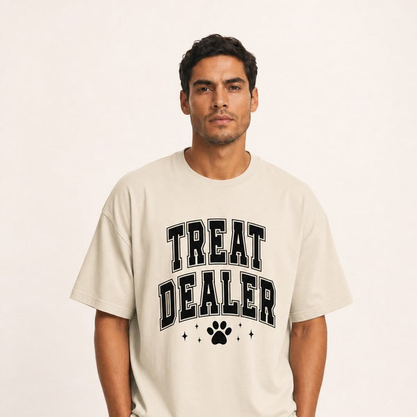 A model wearing a cream Treat Dealer varsity paw print cotton tee.