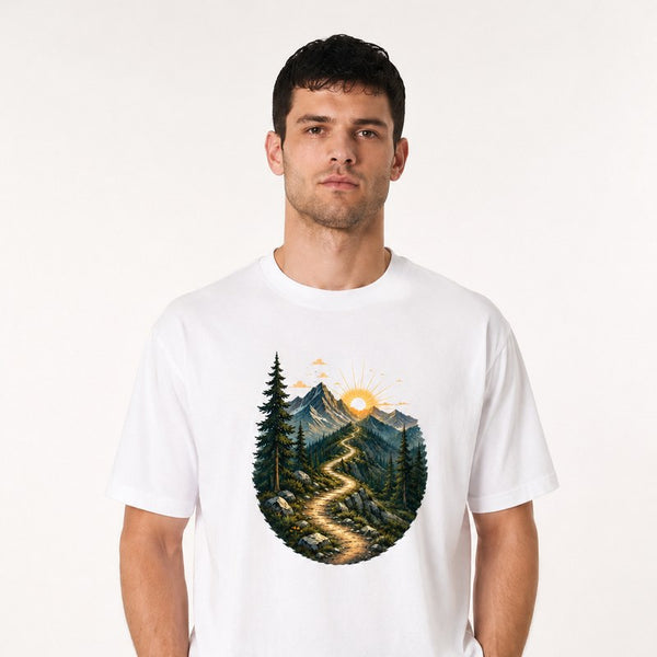 A model wearing a white tee printed with an illustrated mountain trail at sunrise.