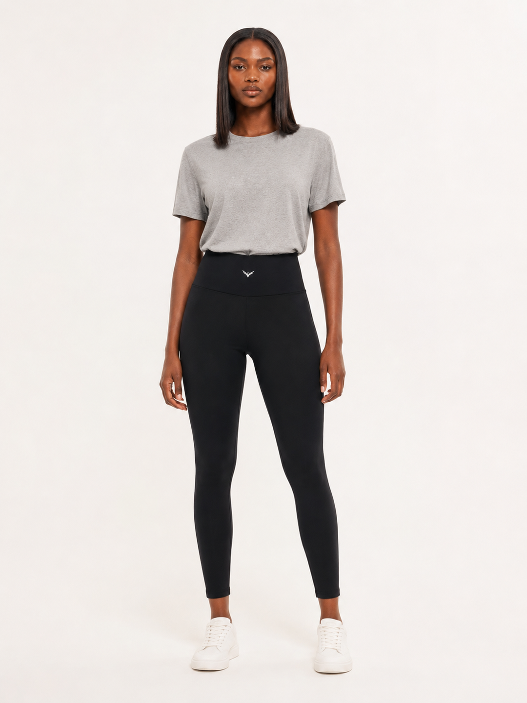 Model wearing black high-rise ankle-length leggings, carrying the GALOVTE ornate winged G logo.