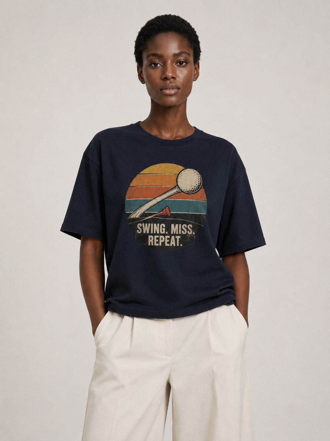 Swing Miss Repeat Retro Golf Oversized Tee in very dark navy, worn by a model.