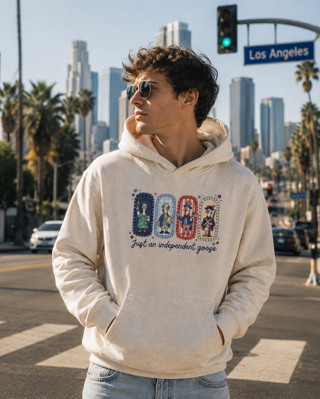 Just An Independent Goose Fourth of July Hoodie in Oat Gray, worn on a Los Angeles street.