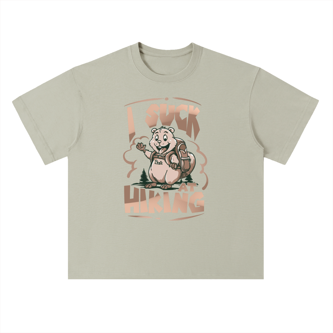 I Suck At Hiking Funny Cartoon Bear Tee in Gray Green, flat lay.