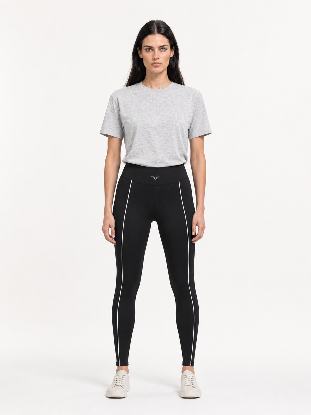Model wearing black high-waist leggings with white piping down each leg, carrying the GALOVTE winged chevron logo.