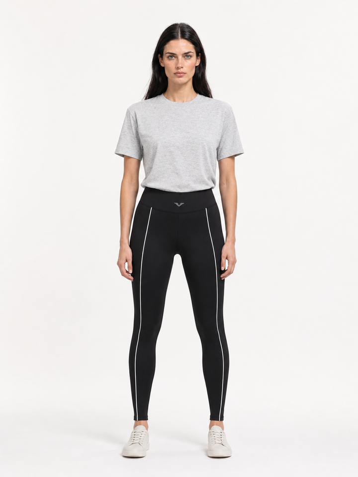 Model wearing black high-waist leggings with white piping down each leg, carrying the GALOVTE winged chevron logo.