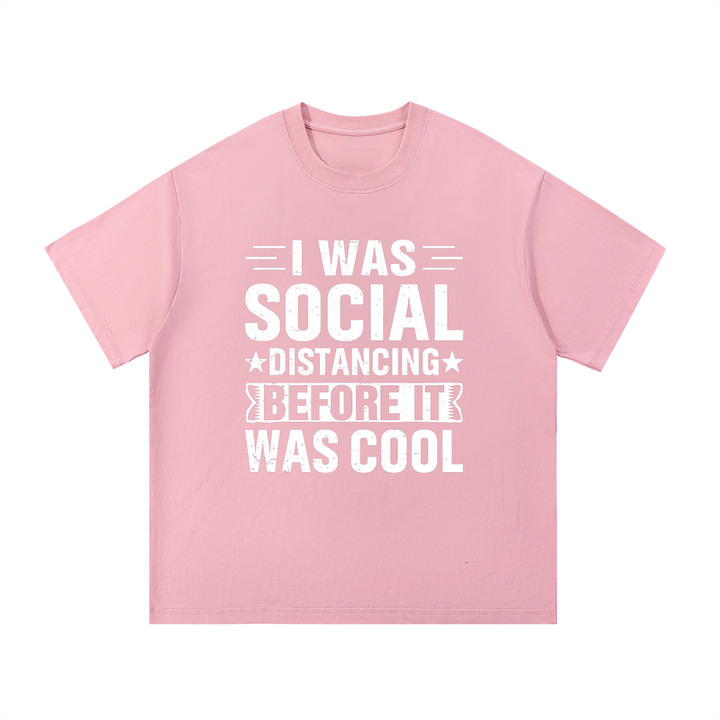 Social Distancing Before It Was Cool Funny Tee in Pink, flat lay.