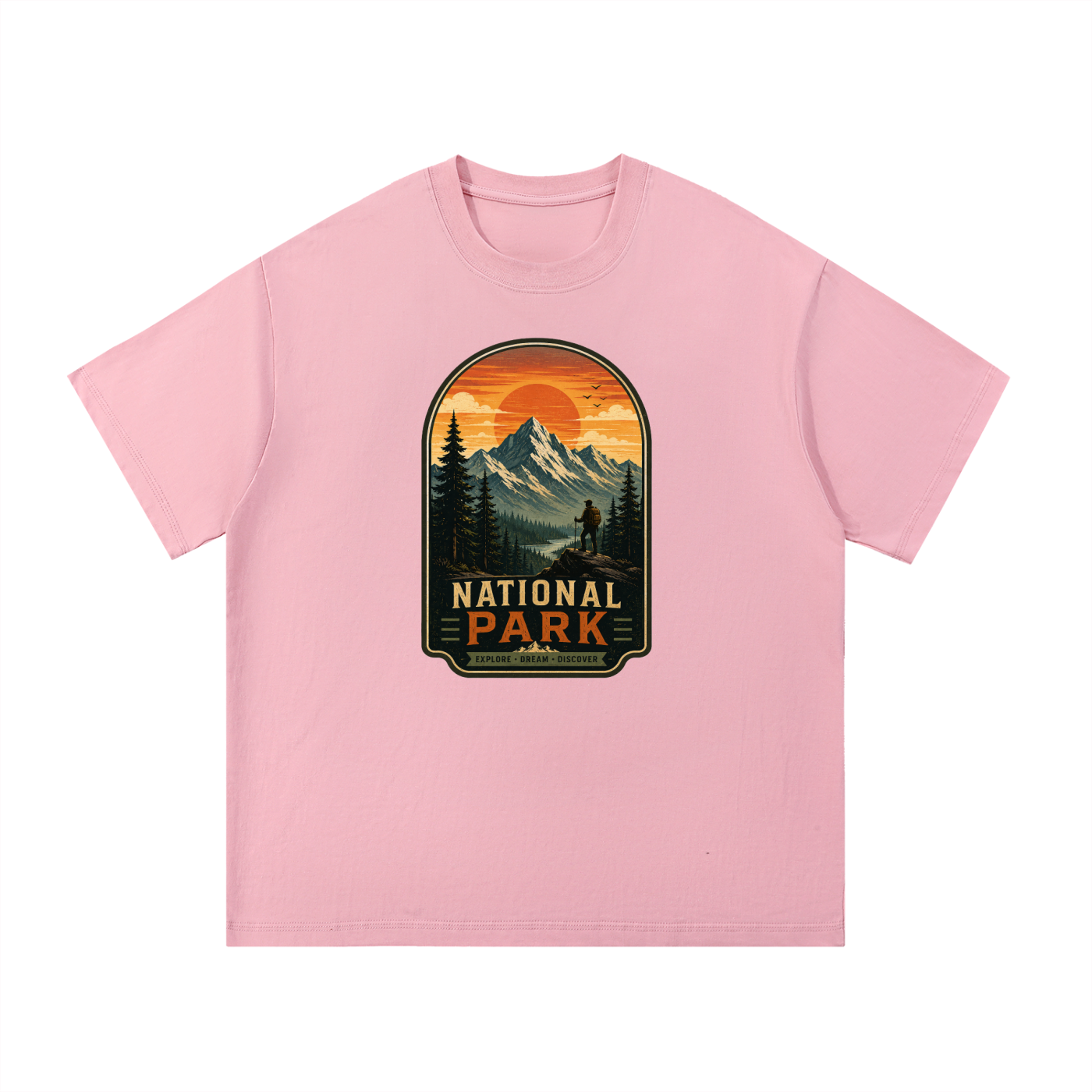 National Park Explore Dream Discover Badge Tee in Pink, flat lay.