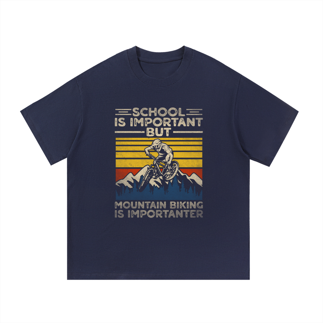 Mountain Biking Is Importanter Funny Tee in Navy Blue, flat lay.