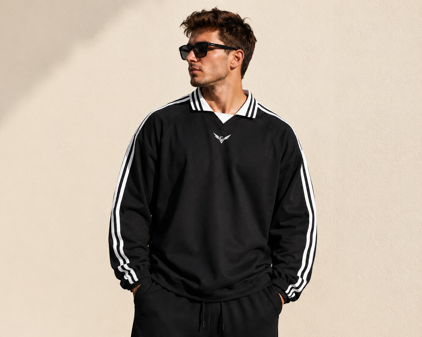 Wing Logo Contrast Stripe Collared Sweatshirt in Black, worn against a plain wall.