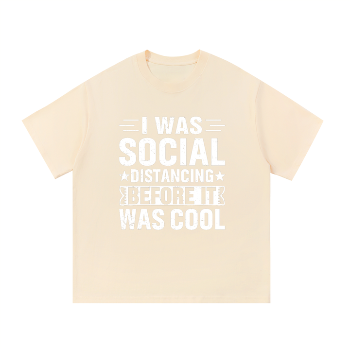 Social Distancing Before It Was Cool Funny Tee in Apricot, flat lay.