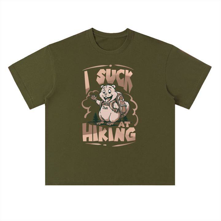 I Suck At Hiking Funny Cartoon Bear Tee in Jungle Green, flat lay.