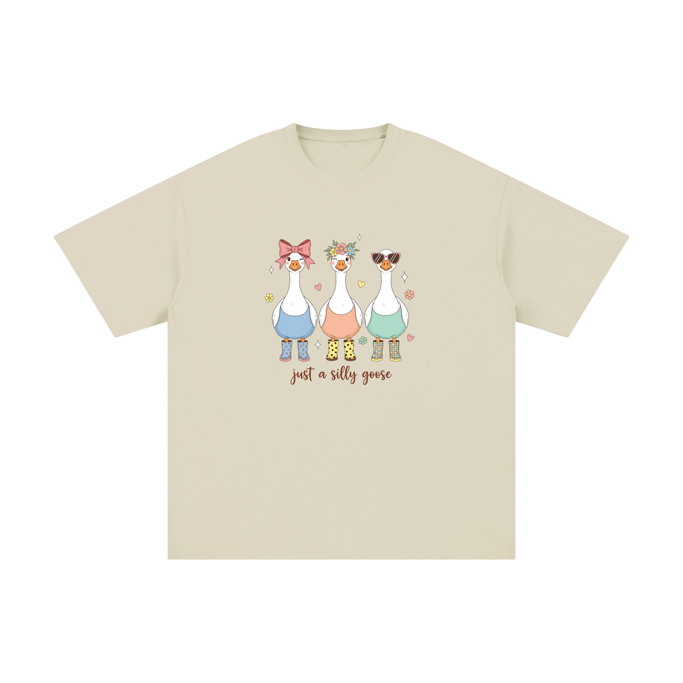 Just A Silly Goose Trio Pastel Cotton Tee in Light Apricot, flat lay.