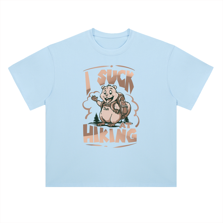 I Suck At Hiking Funny Cartoon Bear Tee in Light Blue, flat lay.