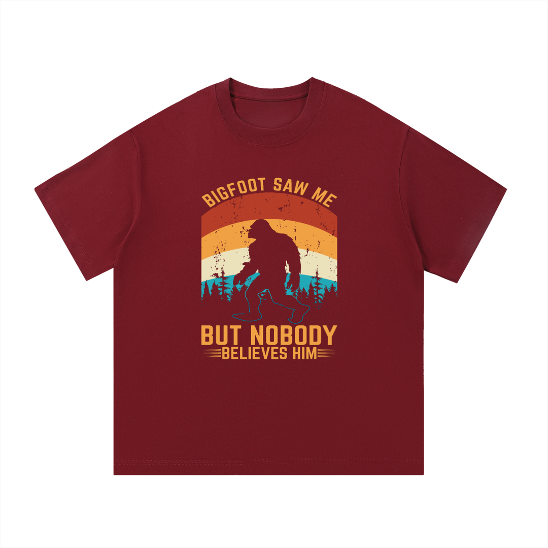 Bigfoot Saw Me But Nobody Believes Him Retro Tee in Wine Red, flat lay.