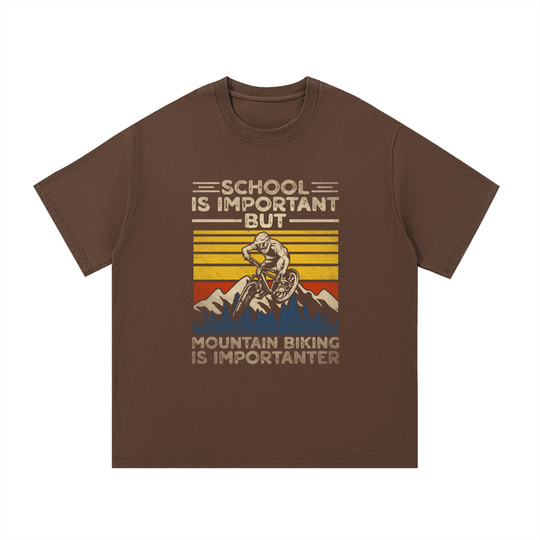 Mountain Biking Is Importanter Funny Tee in Coffee, flat lay.