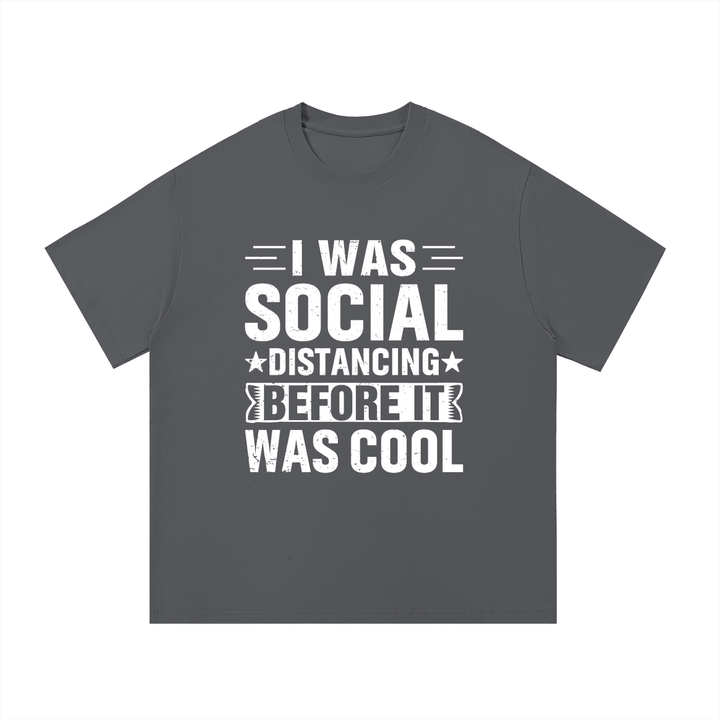 Social Distancing Before It Was Cool Funny Tee in Dark Gray, flat lay.