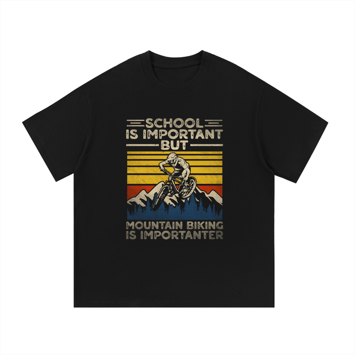 Mountain Biking Is Importanter Funny Tee in Black, flat lay.