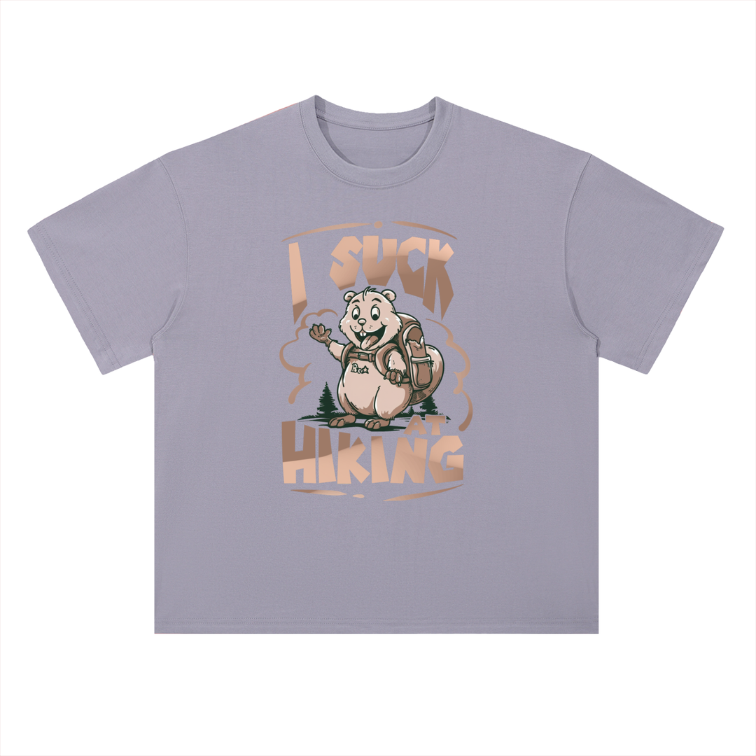 I Suck At Hiking Funny Cartoon Bear Tee in Light Purple, flat lay.