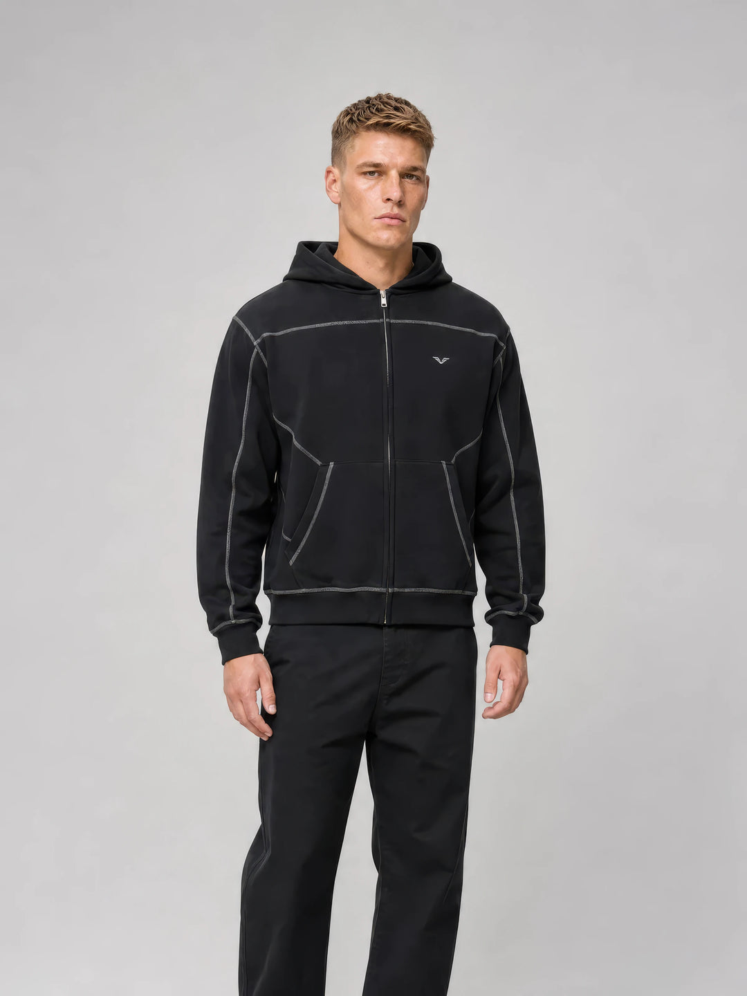Model in a black GALOVTE contrast-stitch zip hoodie set
