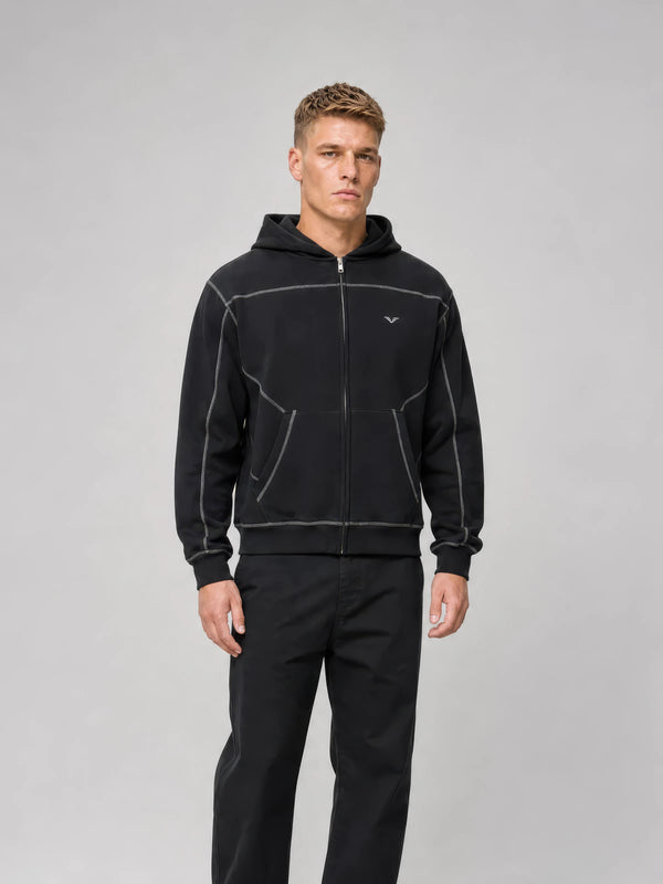 Model in a black GALOVTE contrast-stitch zip hoodie set