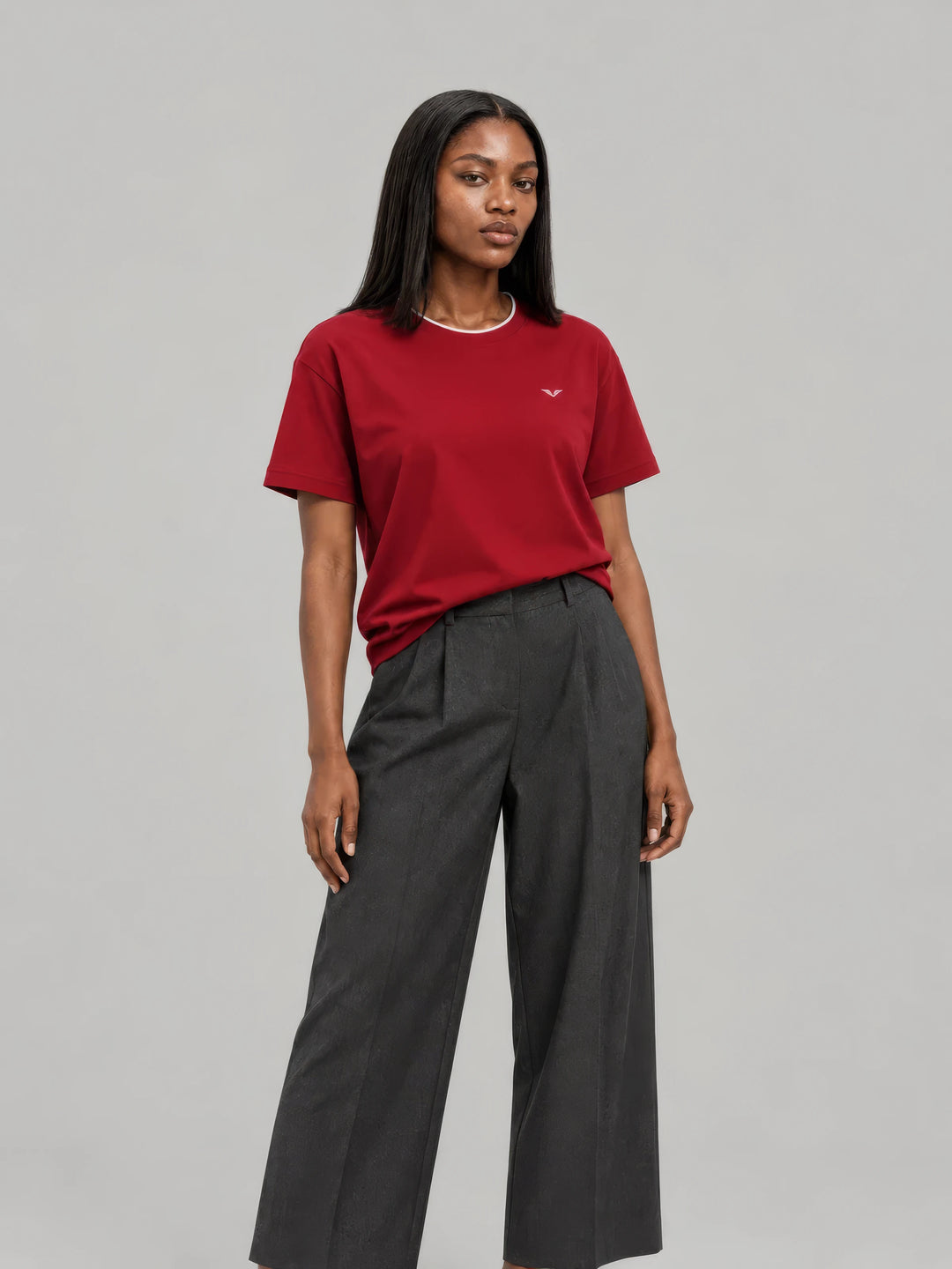 Model in a wine-red GALOVTE crewneck tee and charcoal wide-leg trousers