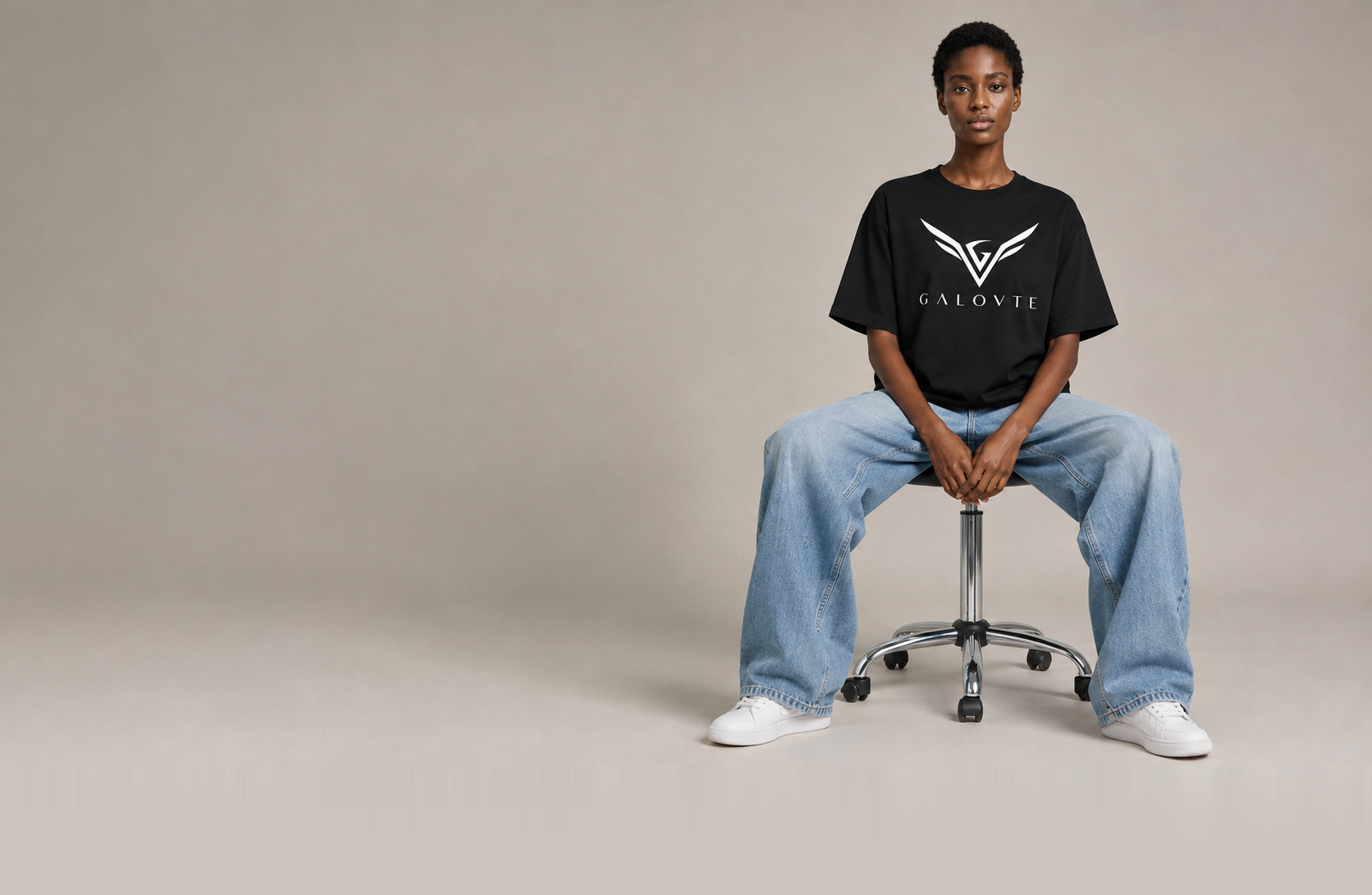 GALOVTE campaign image: model wearing a black GALOVTE logo tee, photographed on a studio sweep.